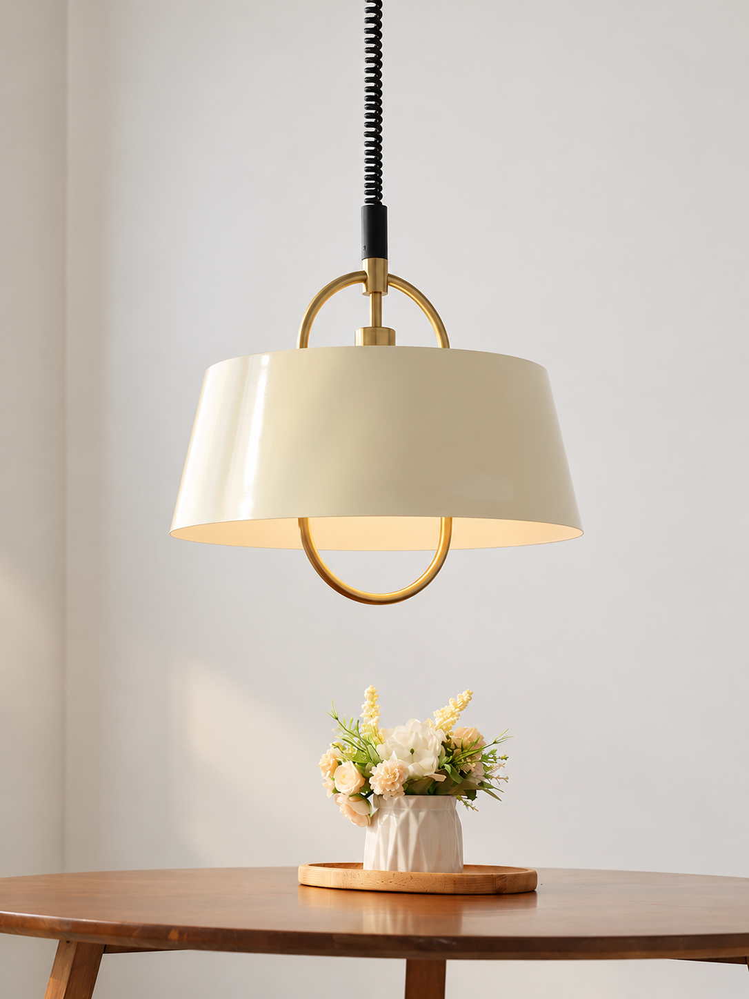 Cream oval-loop pendant over a dining table