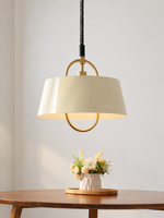 Cream oval-loop pendant over a dining table