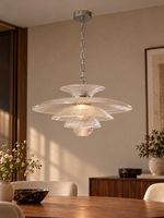 Tiered ribbed clear glass pendant above walnut dining table
