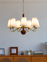 MD4596 7-light chandelier with white pleated fabric shades, copper-tone arms and walnut-colored wood