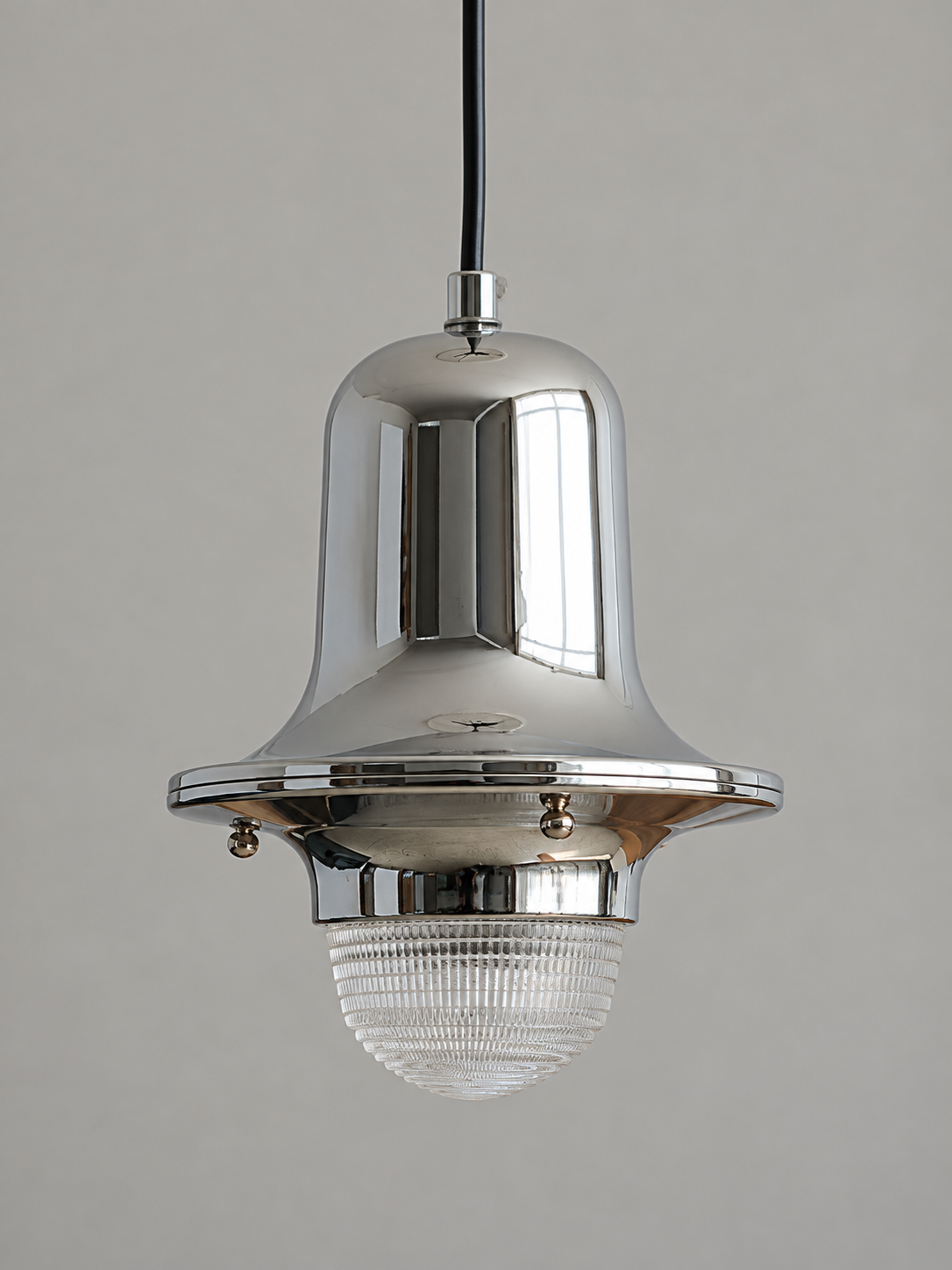 Angled view of chrome bell body and clear textured glass dome