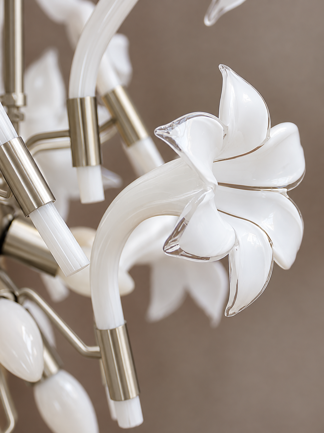 Close-up of a white glass lily with clear petal edges and nickel sleeve