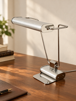 Chrome Line reading table lamp on a walnut desk, three-quarter view