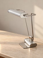 Side view of the Chrome Line reading lamp showing its frame and base