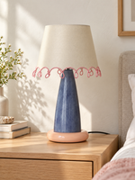 Loop Trim Colorblock Table Lamp with an ivory shade, pink loop trim, blue stem and peach-pink base