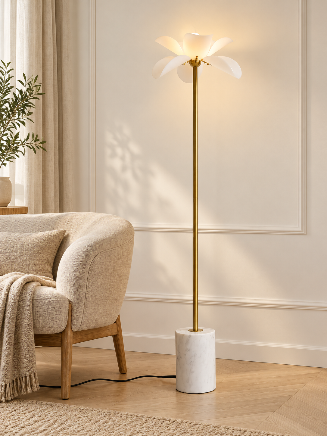 Petal Stem floor lamp with copper-finish stem and white marble base beside a reading chair