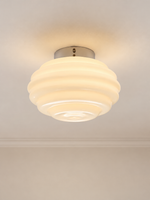 Tiered glass light with chrome base mounted on a ceiling