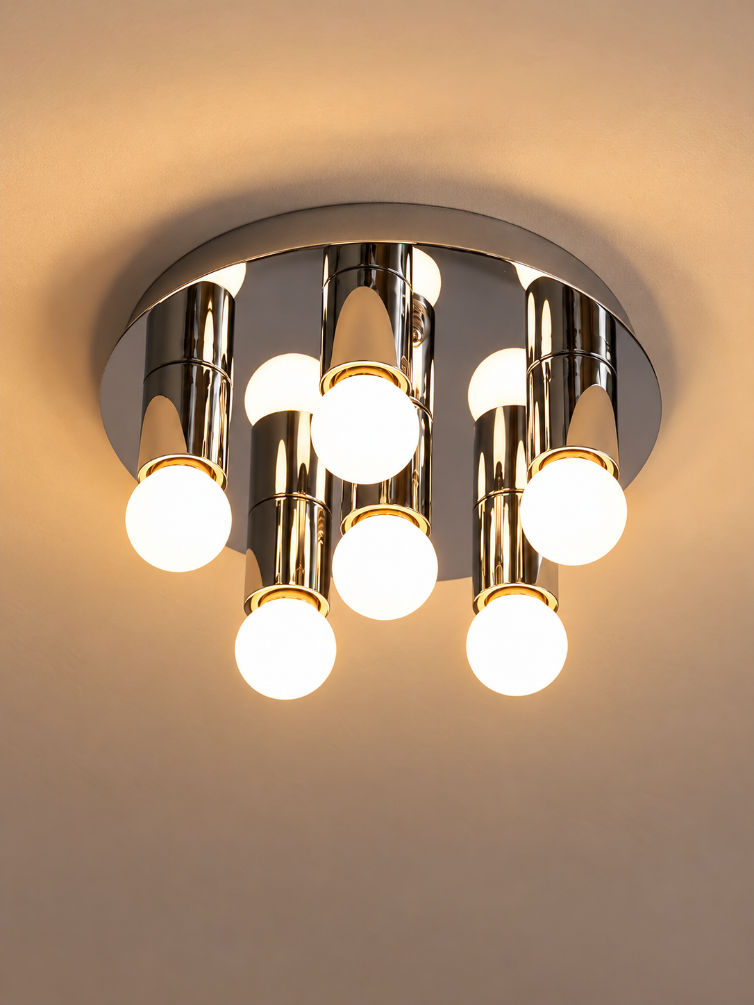 Six glowing milky-white globes and polished chrome ceiling canopy