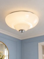Opal Tier glass ceiling light with warm illumination in a blue dressing room