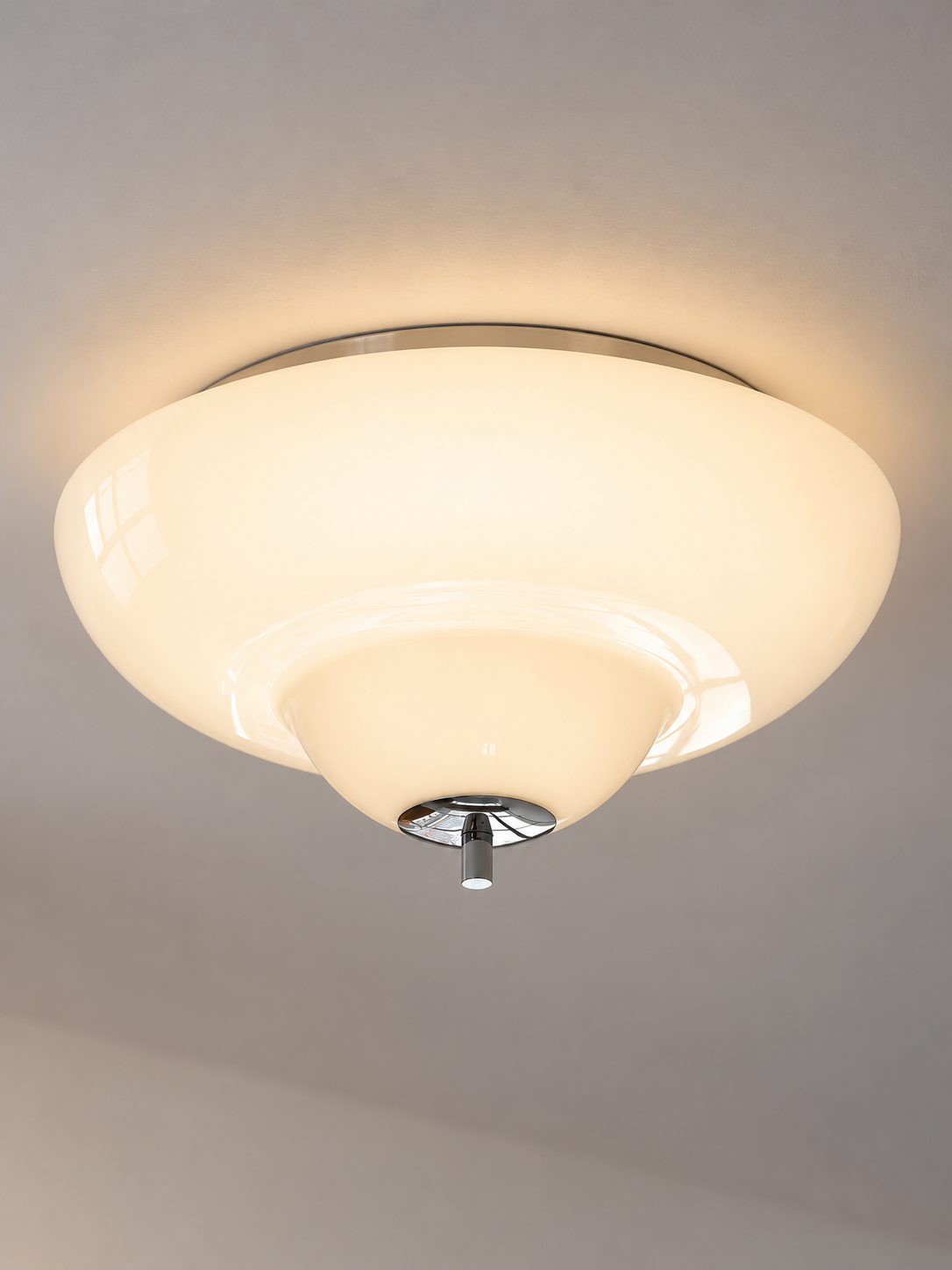 Close view of the stepped opal glass shade and chrome cap