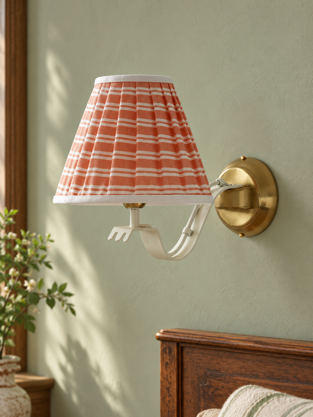 Ruffle Arm Fabric Wall Sconce with coral and white striped shade, switched off against a sage wall